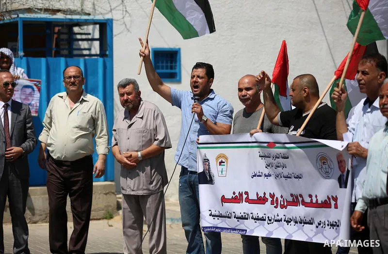 Palestinians take part in a protest against Israel's plan to annex parts of the occupied territory and against US President Donald Trump's Century Deal "expected peace plan", in front of the headquarter United Nation "UN...
