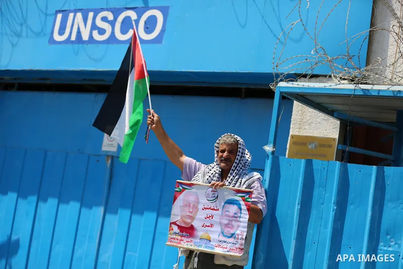 Palestinians take part in a protest against Israel's plan to annex parts of the occupied territory and against US President Donald Trump's Century Deal "expected peace plan", in front of the headquarter United Nation "UN...