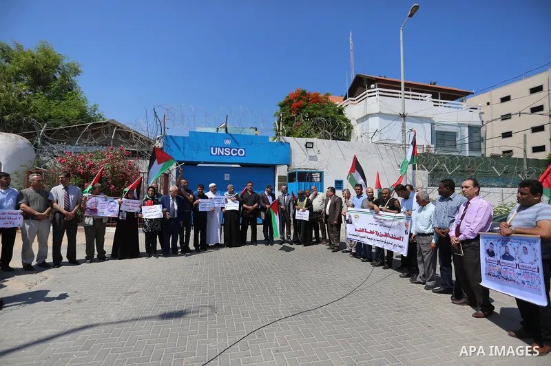 Palestinians take part in a protest against Israel's plan to annex parts of the occupied territory and against US President Donald Trump's Century Deal "expected peace plan", in front of the headquarter United Nation "UN...
