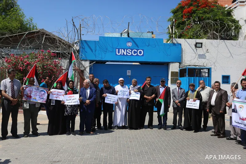 Palestinians take part in a protest against Israel's plan to annex parts of the occupied territory and against US President Donald Trump's Century Deal "expected peace plan", in front of the headquarter United Nation "UN...