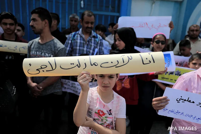 Palestinians formerly employed by United Nations Relief and Works Agency (UNRWA) take part in a protest demanding their rights, outside its headquarter office, in Gaza City on June 30, 2020. Photo by Mahmoud Nasser