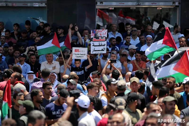 Palestinians hold placards and national flags during a demonstration against Israel's West Bank annexation plans in Gaza City on July 1, 2020. Israel's Prime Minister Benjamin Netanyahu, emboldened by the US Mideast plan...