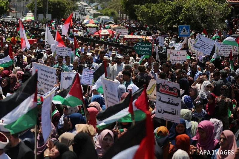 Palestinians hold placards and national flags during a demonstration against Israel's West Bank annexation plans in Gaza City on July 1, 2020. Israel's Prime Minister Benjamin Netanyahu, emboldened by the US Mideast plan...