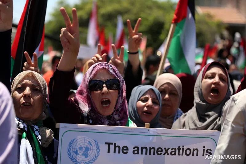 Palestinians hold placards and national flags during a demonstration against Israel's West Bank annexation plans in Gaza City on July 1, 2020. Israel's Prime Minister Benjamin Netanyahu, emboldened by the US Mideast plan...