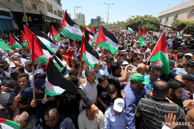 Palestinians hold placards and national flags during a demonstration against Israel's West Bank annexation plans in Gaza City on July 1, 2020. Israel's Prime Minister Benjamin Netanyahu, emboldened by the US Mideast plan...