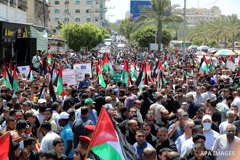 Palestinians hold placards and national flags during a demonstration against Israel's West Bank annexation plans in Gaza City on July 1, 2020. Israel's Prime Minister Benjamin Netanyahu, emboldened by the US Mideast plan...