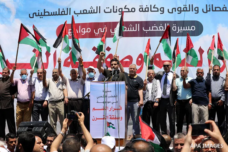 Palestinians hold placards and national flags during a demonstration against Israel's West Bank annexation plans in Gaza City on July 1, 2020. Israel's Prime Minister Benjamin Netanyahu, emboldened by the US Mideast plan...