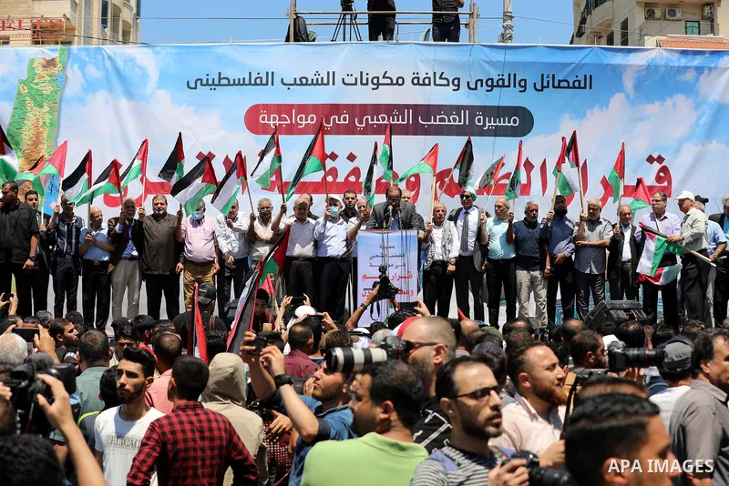 Palestinians hold placards and national flags during a demonstration against Israel's West Bank annexation plans in Gaza City on July 1, 2020. Israel's Prime Minister Benjamin Netanyahu, emboldened by the US Mideast plan...