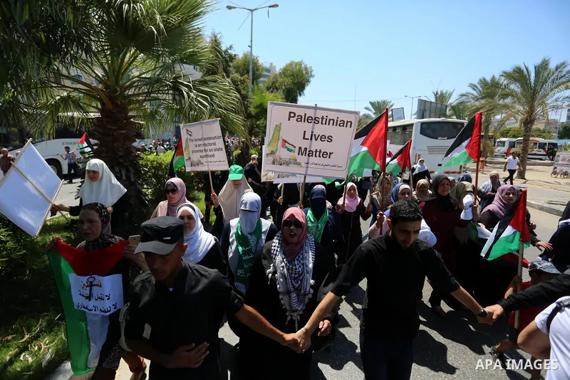 Palestinians hold placards and national flags during a demonstration against Israel's West Bank annexation plans in Gaza City on July 1, 2020. Israel's Prime Minister Benjamin Netanyahu, emboldened by the US Mideast plan...