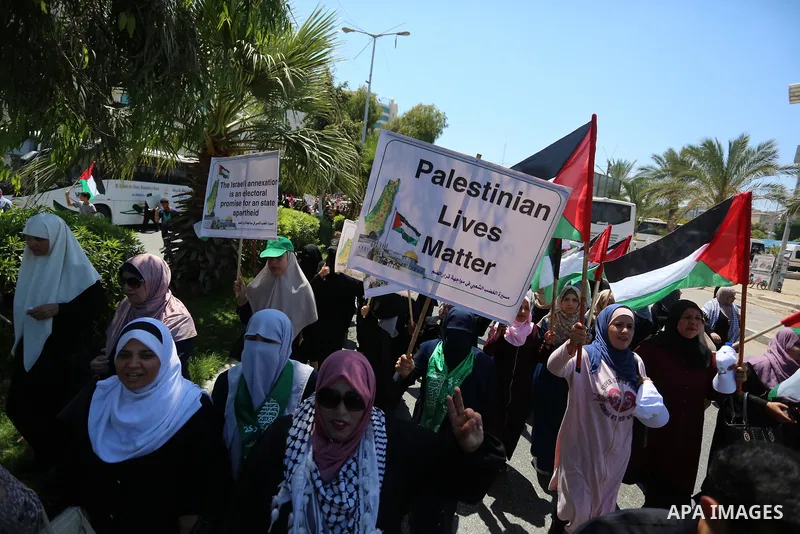 Palestinians hold placards and national flags during a demonstration against Israel's West Bank annexation plans in Gaza City on July 1, 2020. Israel's Prime Minister Benjamin Netanyahu, emboldened by the US Mideast plan...