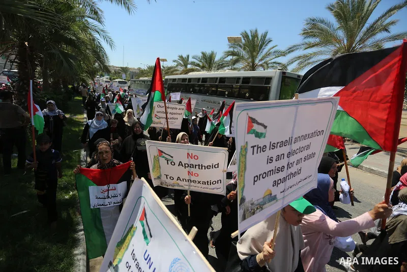 Palestinians hold placards and national flags during a demonstration against Israel's West Bank annexation plans in Gaza City on July 1, 2020. Israel's Prime Minister Benjamin Netanyahu, emboldened by the US Mideast plan...