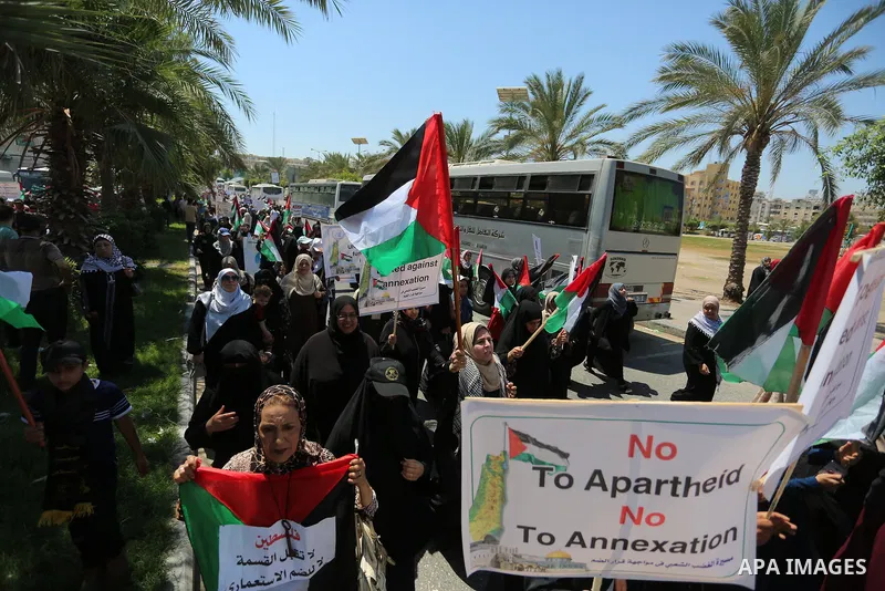Palestinians hold placards and national flags during a demonstration against Israel's West Bank annexation plans in Gaza City on July 1, 2020. Israel's Prime Minister Benjamin Netanyahu, emboldened by the US Mideast plan...