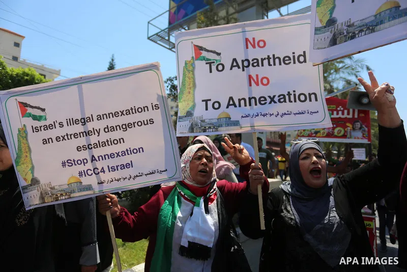 Palestinians hold placards and national flags during a demonstration against Israel's West Bank annexation plans in Gaza City on July 1, 2020. Israel's Prime Minister Benjamin Netanyahu, emboldened by the US Mideast plan...