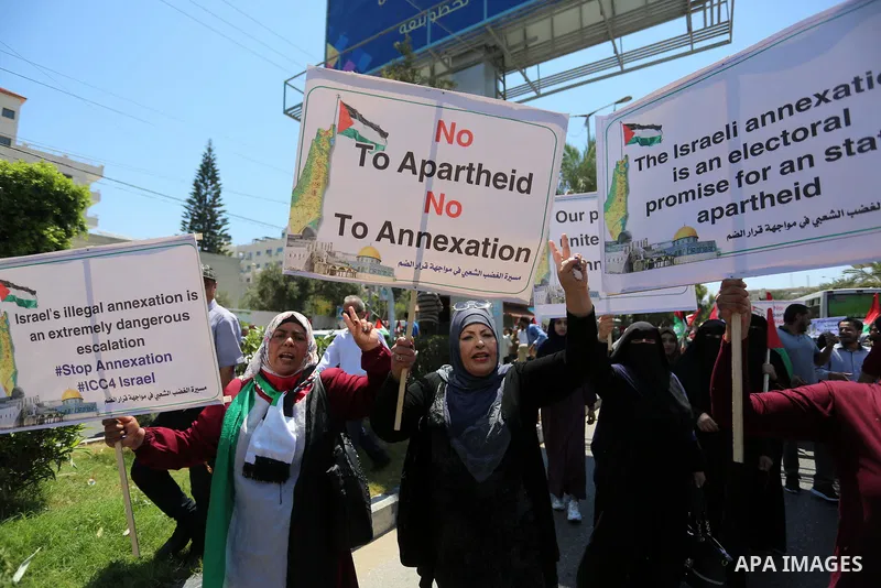 Palestinians hold placards and national flags during a demonstration against Israel's West Bank annexation plans in Gaza City on July 1, 2020. Israel's Prime Minister Benjamin Netanyahu, emboldened by the US Mideast plan...