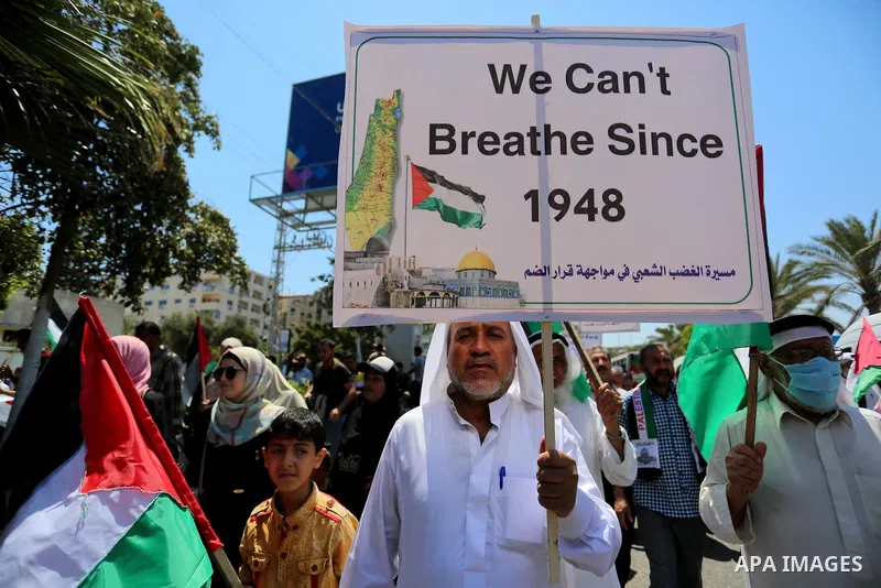 Palestinians hold placards and national flags during a demonstration against Israel's West Bank annexation plans in Gaza City on July 1, 2020. Israel's Prime Minister Benjamin Netanyahu, emboldened by the US Mideast plan...