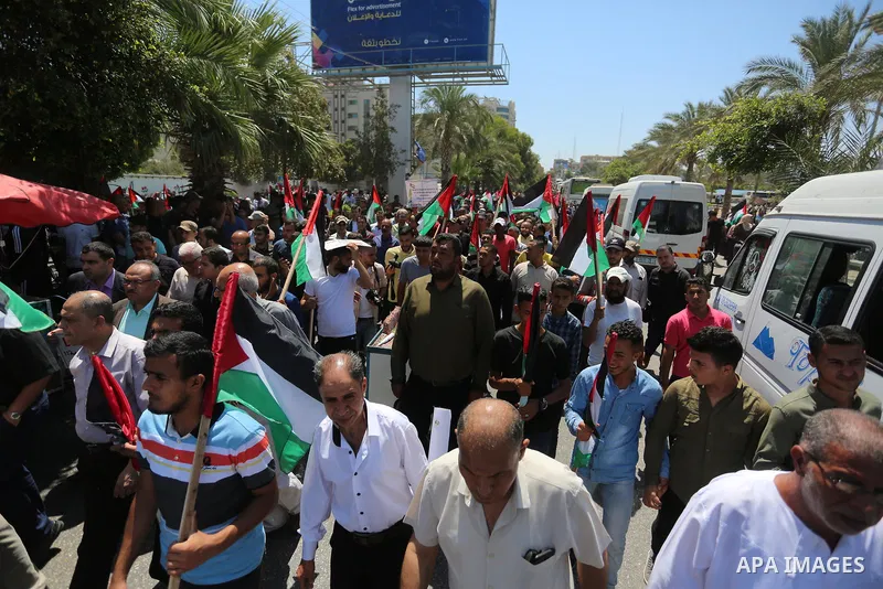 Palestinians hold placards and national flags during a demonstration against Israel's West Bank annexation plans in Gaza City on July 1, 2020. Israel's Prime Minister Benjamin Netanyahu, emboldened by the US Mideast plan...