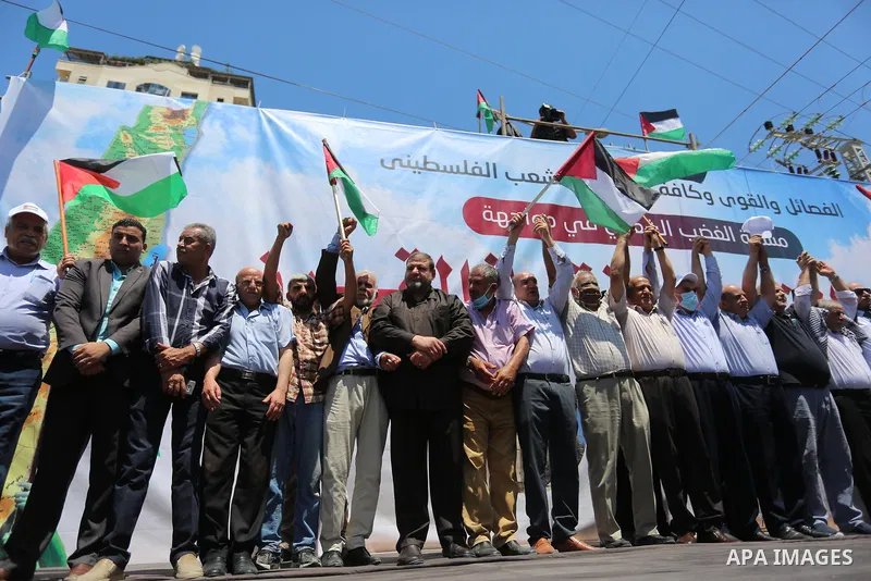 Palestinians hold placards and national flags during a demonstration against Israel's West Bank annexation plans in Gaza City on July 1, 2020. Israel's Prime Minister Benjamin Netanyahu, emboldened by the US Mideast plan...