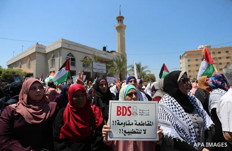 Palestinians hold placards and national flags during a demonstration against Israel's West Bank annexation plans in Gaza City on July 1, 2020. Israel's Prime Minister Benjamin Netanyahu, emboldened by the US Mideast plan...