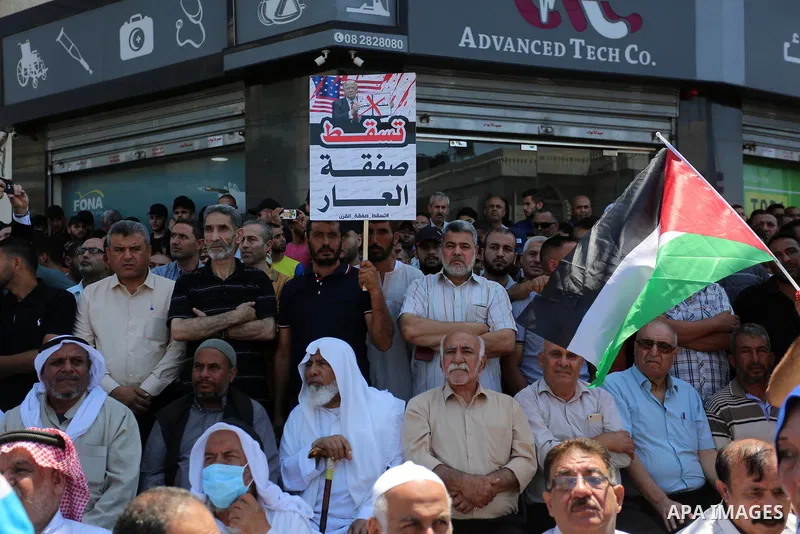 Palestinians hold placards and national flags during a demonstration against Israel's West Bank annexation plans in Gaza City on July 1, 2020. Israel's Prime Minister Benjamin Netanyahu, emboldened by the US Mideast plan...