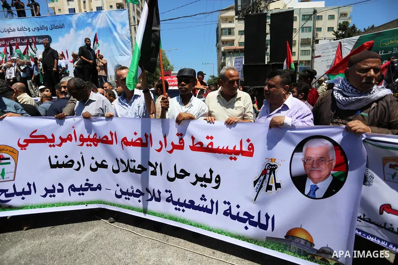 Palestinians hold placards and national flags during a demonstration against Israel's West Bank annexation plans in Gaza City on July 1, 2020. Israel's Prime Minister Benjamin Netanyahu, emboldened by the US Mideast plan...