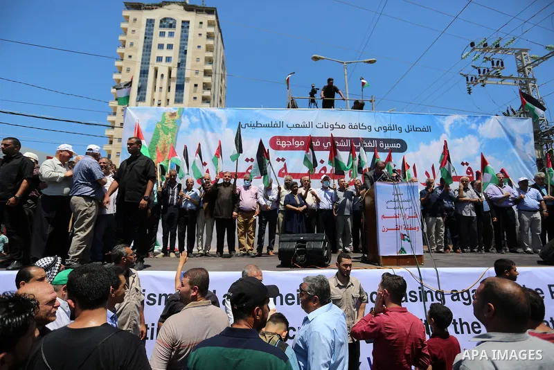 Palestinians hold placards and national flags during a demonstration against Israel's West Bank annexation plans in Gaza City on July 1, 2020. Israel's Prime Minister Benjamin Netanyahu, emboldened by the US Mideast plan...