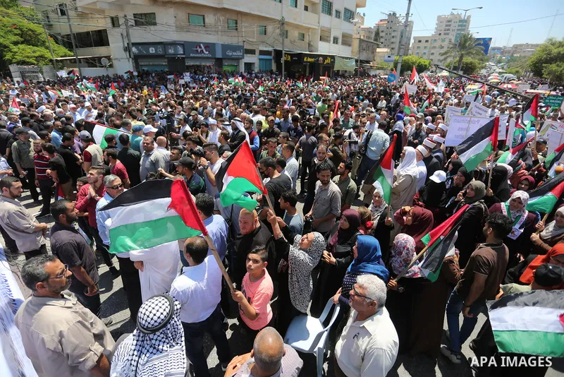 Palestinians hold placards and national flags during a demonstration against Israel's West Bank annexation plans in Gaza City on July 1, 2020. Israel's Prime Minister Benjamin Netanyahu, emboldened by the US Mideast plan...