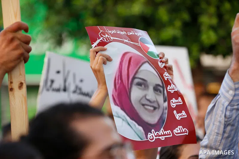 Palestinians hold placards and national flags during a demonstration against Israel's West Bank annexation plans in the West Bank city of Ramallah on July 1, 2020. Israel's Prime Minister Benjamin Netanyahu, emboldened b...