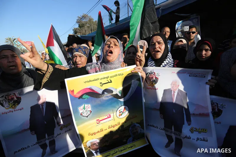 Palestinians waves national flags and hold posters of Palestinian President Mahmud Abbas during a demonstration against Israel's West Bank annexation plans in Khan Younis in the southern Gaza Strip, on July 2, 2020. Isra...