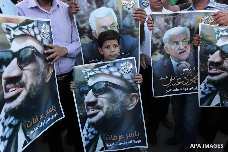 Palestinians waves national flags and hold posters of Palestinian President Mahmud Abbas during a demonstration against Israel's West Bank annexation plans in Khan Younis in the southern Gaza Strip, on July 2, 2020. Isra...