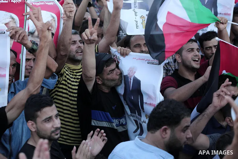Palestinians waves national flags and hold posters of Palestinian President Mahmud Abbas during a demonstration against Israel's West Bank annexation plans in Khan Younis in the southern Gaza Strip, on July 2, 2020. Isra...