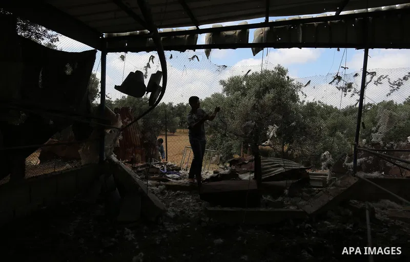 A Palestinian bor inspects a damaged farm after an Israeli air strike in the east of the Gaza Strip, on July 6, 2020. Three rockets were fired from the northern Gaza Strip into Israel Sunday evening, as tensions along th...