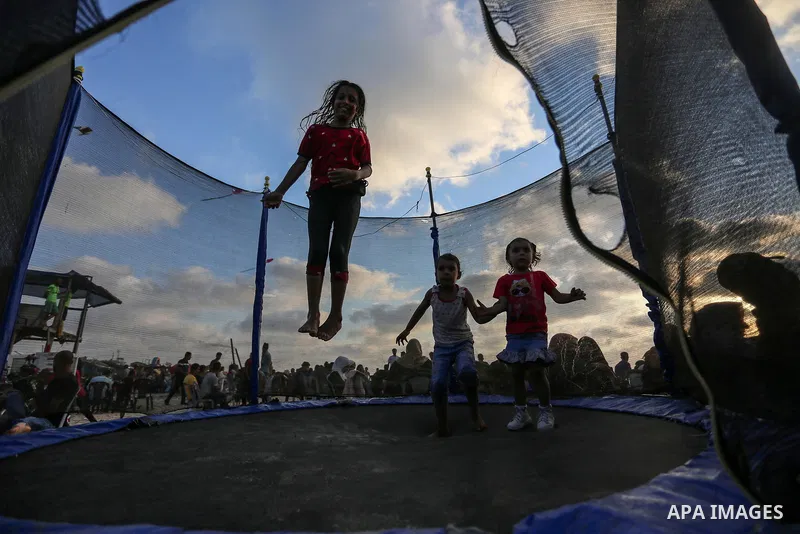 Palestinians enjoy at the beach a sunny summer day in Khan Yunis, southern of Gaza Strip, on July 24, 2020. Photo by Ashraf Amra