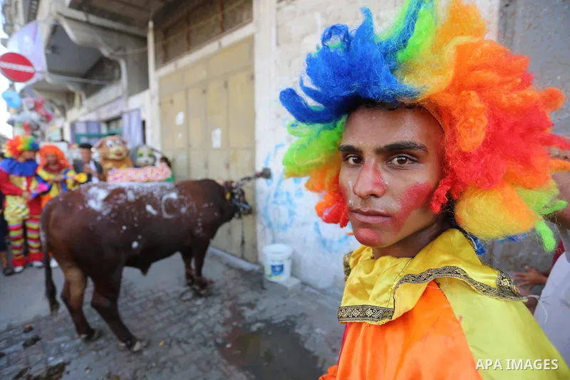 Palestinian clowns have fun with sacrificial animals ahead of Eid al-Adha festival in Khan Yunis in the southern Gaza Strip, on July 30, 2020. Muslims across the world are preparing for Eid al-Adha holiday when custom re...