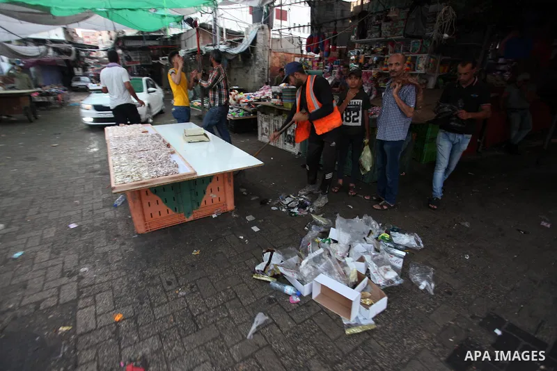 Palestinian Cleaners work at a street on the first day of Eid al-Adha, or feast of the sacrifice in Gaza city on July 31, 2020. Muslims are celebrating Eid al-Adha (the feast of sacrifice), the second of two Islamic holi...