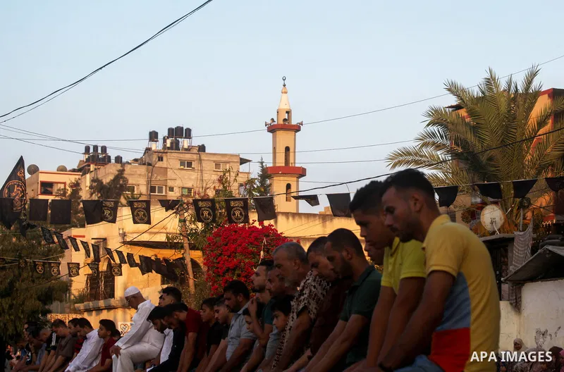 Palestinian Muslims sacrifice livestock as part of the commemoration for the first day of Eid al-Adha or feast of the sacrifice, in Beit Lahia, in the northern Gaza Strip on July 31, 2020. Muslims are celebrating Eid al-...