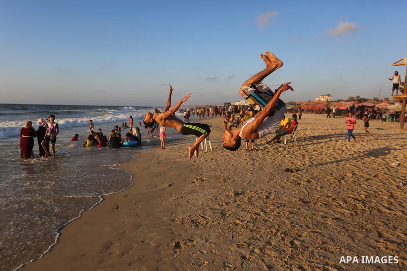 Palestinians enjoy the beach of the Mediterranean sea during the Eid al-Adha holiday or feast of the sacrifice, in Khan Younis southern Gaza strip on August 2, 2020. Muslims are celebrating Eid al-Adha (the feast of sacr...