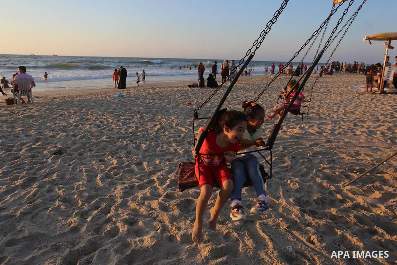 Palestinians enjoy the beach of the Mediterranean sea during the Eid al-Adha holiday or feast of the sacrifice, in Khan Younis southern Gaza strip on August 2, 2020. Muslims are celebrating Eid al-Adha (the feast of sacr...