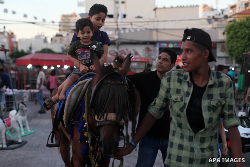 Palestinian children celebrate during the Eid al-Adha holiday or feast of the sacrifice, in Gaza city on August 2, 2020. Muslims are celebrating Eid al-Adha (the feast of sacrifice), the second of two Islamic holidays ce...