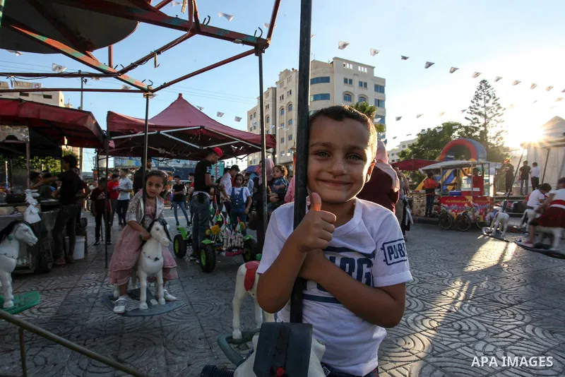 Palestinian children celebrate during the Eid al-Adha holiday or feast of the sacrifice, in Gaza city on August 2, 2020. Muslims are celebrating Eid al-Adha (the feast of sacrifice), the second of two Islamic holidays ce...