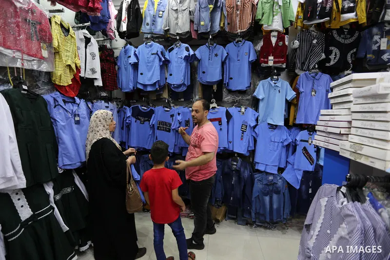 Palestinians shop during preparation for the new school year at a market in Khan Younis southern of Gaza strip, on August 4, 2020. Photo by Ashraf Amra