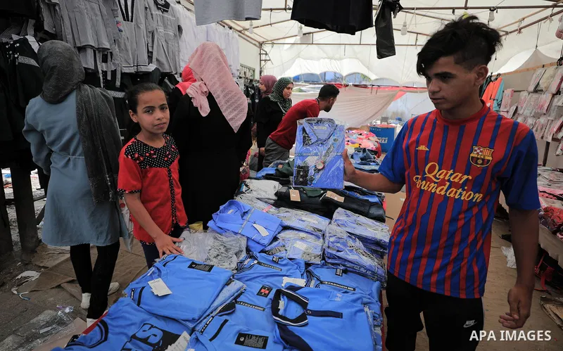 Palestinians shop during preparation for the new school year at a market in Gaza city, on August 5, 2020. Photo by Mahmoud Nasser