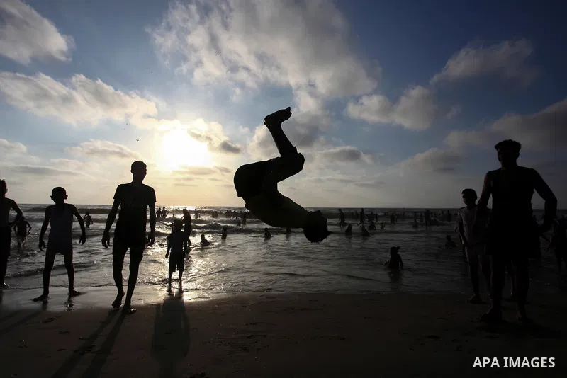 Palestinians enjoy at the beach a sunny summer day in Gaza city on August 7, 2020. Photo by Mahmoud Ajjour