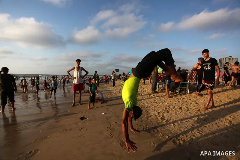Palestinians enjoy at the beach a sunny summer day in Gaza city on August 7, 2020. Photo by Mahmoud Ajjour