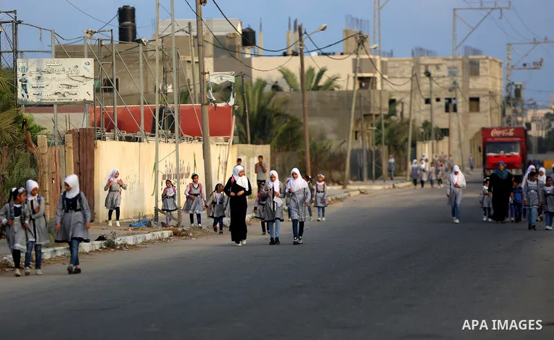 Palestinian students return back to their school in the morning of the first day of the new year study, in Dair Al Balah in the central of Gaza Strip, on August 8, 2020. Photo by Ashraf Amra
