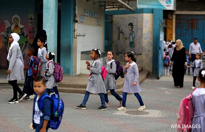 Palestinian students return back to their school in the morning of the first day of the new year study, in Dair Al Balah in the central of Gaza Strip, on August 8, 2020. Photo by Ashraf Amra