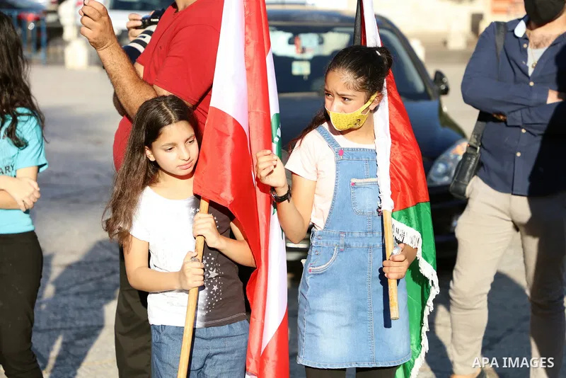 Palestinians light candles to express their condolences to the Lebanese people, in front of Church of the Nativity, in the West Bank city of Bethlehem, on August 9, 2020. Photo by Abedalrahman Hassan