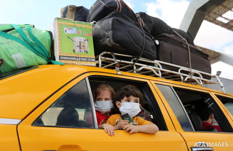 Palestinians wait for travel permits to cross into Egypt through the Rafah border crossing in Rafah in the southern of Gaza Strip, on August 11, 2020. For the first time in five months, Egypt on Tuesday reopened Rafah cr...