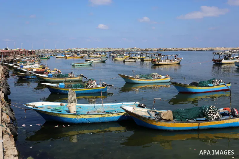 Palestinian fishermen work on their fishing boats at Gaza seaport, on August 13, 2020. The Israeli occupation authorities reduced the fishing area for Gaza fishermen and stopped the entry of fuel into Gaza as part of its...