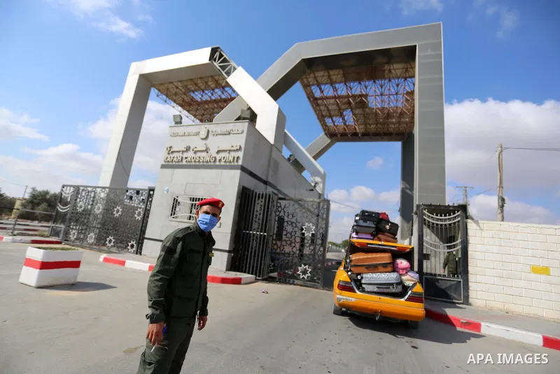 Palestinians wait for travel permits to cross into Egypt through the Rafah border crossing in Rafah in the southern of Gaza Strip, on August 13, 2020. Photo by Ashraf Amra