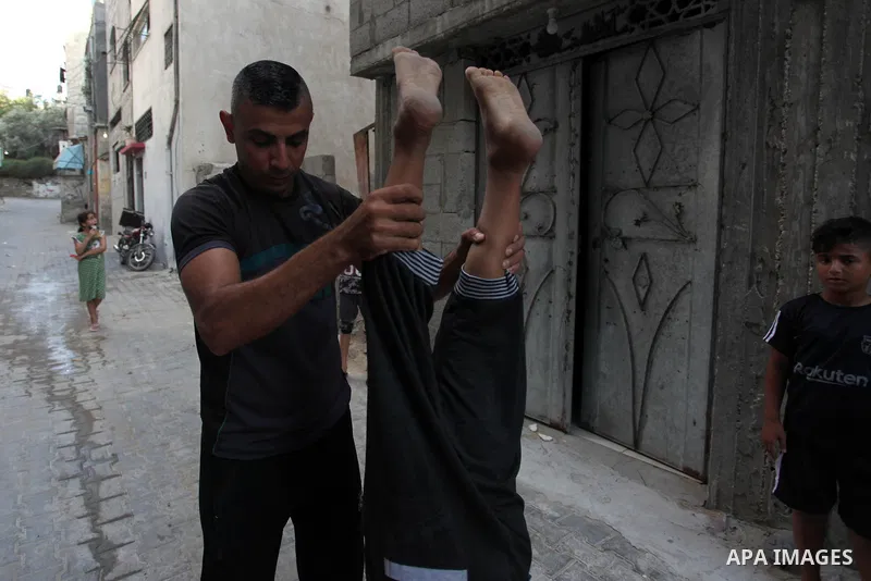 Palestinian parkour trainer Ahmed Abu Hasira "myuz",35, trains children outside his home, in Gaza City on August 18, 2020. Parkour is an activity that can be practiced alone or with others and is usually carried out in u...